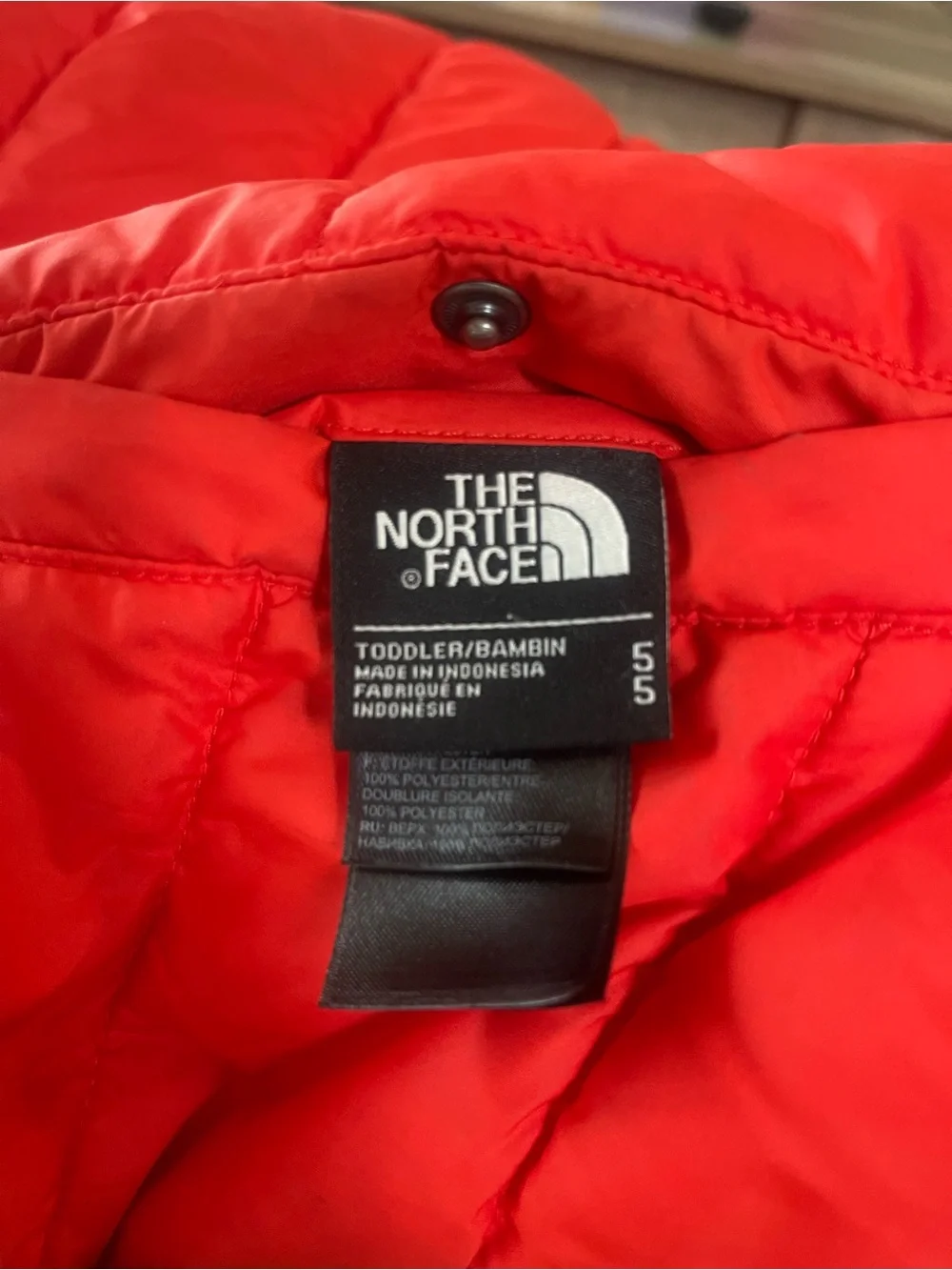The North Face reversible Solid Red or Vibrant Striped side Puffer Jacket.